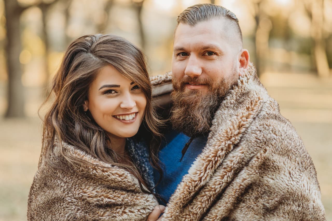 Couple wrapped in a fur blanket